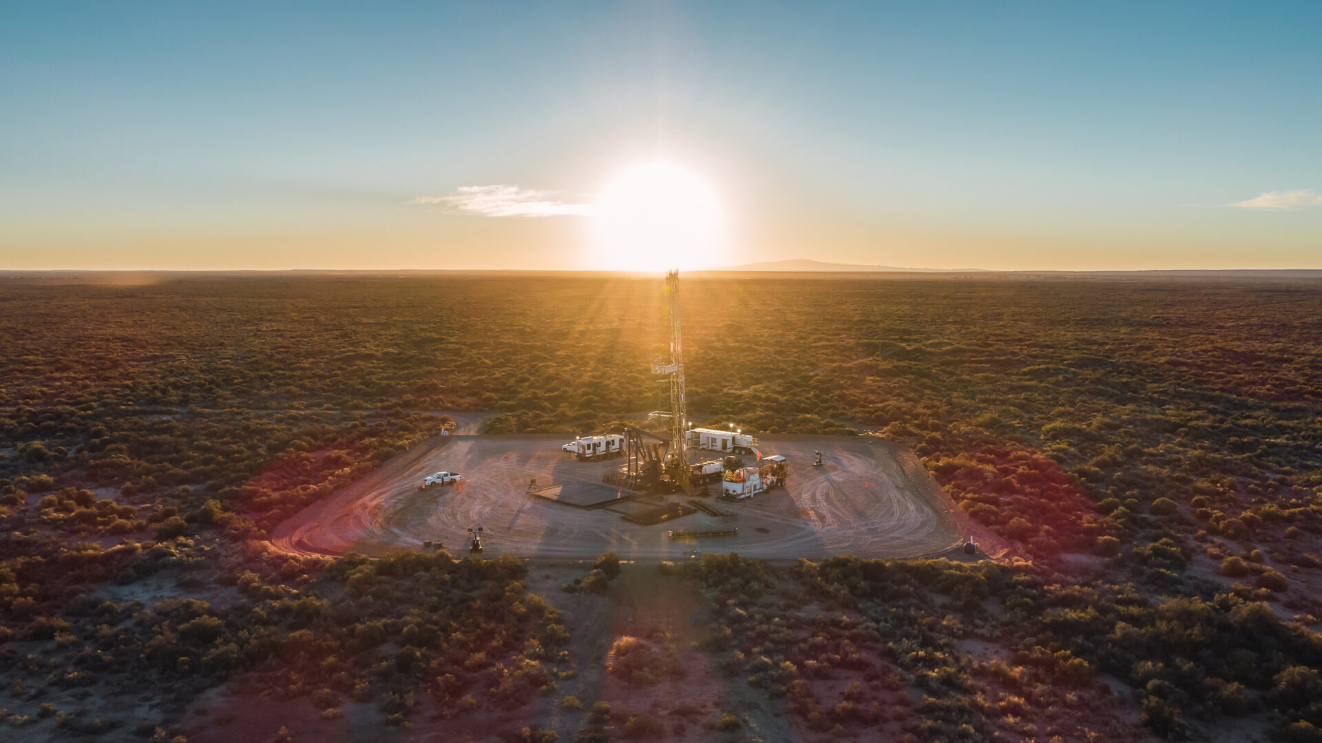 pulling equipment in oil field at sunset